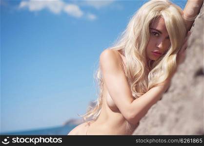 Portrait of beautiful nude blonde on the nudist beach