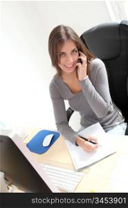 Portrait of beautiful office worker sitting at her desk