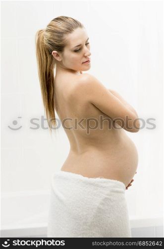 Portrait of beautiful pregnant woman covered in towel