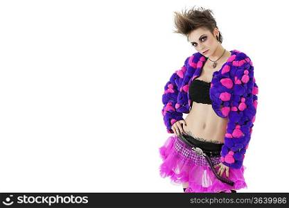 Portrait of beautiful punk woman with hand on hips over white background