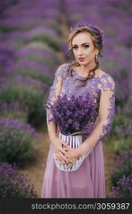 Portrait of beautiful romantic woman in field of lavender with basket of purple lavender flowers, summer time.. Portrait of beautiful romantic woman in field of lavender with basket of purple lavender flowers, summer time