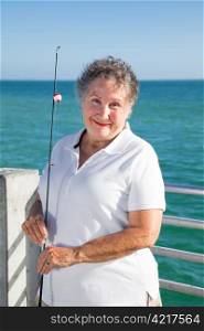 Portrait of beautiful senior woman with her fishing pole.