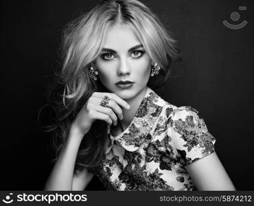 Portrait of beautiful sensual woman with elegant hairstyle. Perfect makeup. Blonde girl. Fashion photo. Jewelry and dress. Black and white