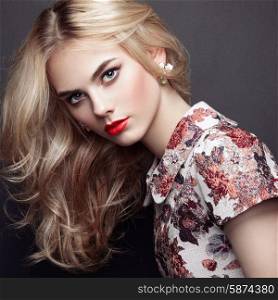 Portrait of beautiful sensual woman with elegant hairstyle. Perfect makeup. Blonde girl. Fashion photo. Jewelry and dress