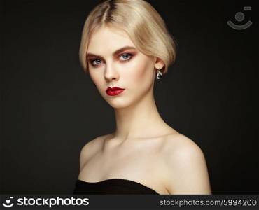 Portrait of beautiful sensual woman with elegant hairstyle. Perfect makeup. Blonde girl. Fashion photo. Jewelry and dress
