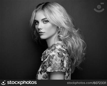 Portrait of beautiful sensual woman with elegant hairstyle. Perfect makeup. Blonde girl. Fashion photo. Jewelry and dress. Black and white