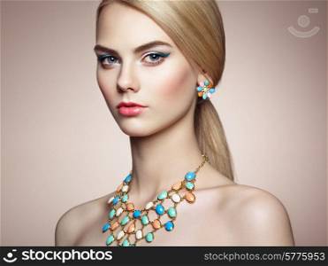 Portrait of beautiful sensual woman with elegant hairstyle. Perfect makeup. Blonde girl. Fashion photo. Jewelry