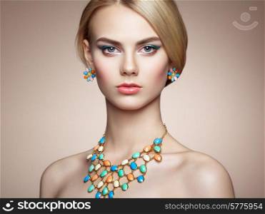 Portrait of beautiful sensual woman with elegant hairstyle. Perfect makeup. Blonde girl. Fashion photo. Jewelry