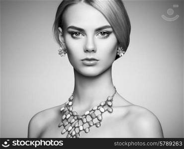 Portrait of beautiful sensual woman with elegant hairstyle. Perfect makeup. Blonde girl. Fashion photo. Jewelry. Black and white