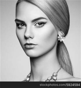 Portrait of beautiful sensual woman with elegant hairstyle. Perfect makeup. Blonde girl. Fashion photo. Jewelry. Black and white