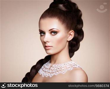 Portrait of beautiful sensual woman with elegant hairstyle. Perfect makeup. Girl pigtailed. Fashion photo