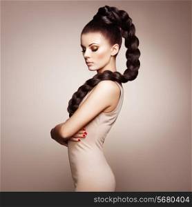 Portrait of beautiful sensual woman with elegant hairstyle. Perfect makeup. Girl pigtailed. Fashion photo