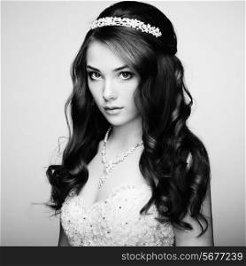 Portrait of beautiful sensual woman with elegant hairstyle. Wedding dress. Fashion photo. Black and white