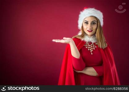 Portrait of beautiful sexy girl wearing Santa Claus clothes on red background
