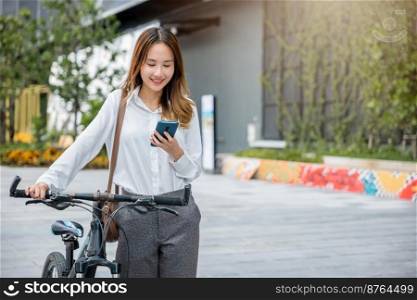 Portrait of beautiful smile business woman commute her bicycle outdoor using smartphone at urban, bike go to work office, Asian businesswoman standing on city street with bicycle holding mobile phone