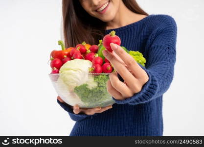 Portrait of beautiful smiling asian woman holding bowl full of fresh organic vegetables isolated on white background, concept of healthy food nutrition, Concept of healthy food nutrition, vegetarian