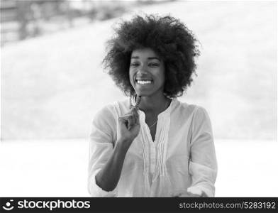 Portrait of beautiful smiling black woman with pen in arm