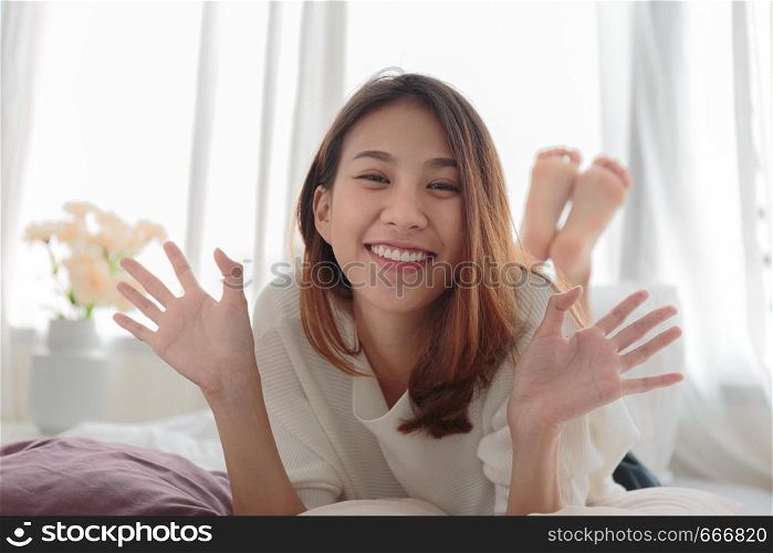 Portrait of beautiful smiling woman in bed at home