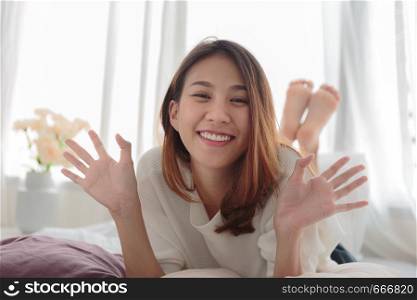 Portrait of beautiful smiling woman in bed at home
