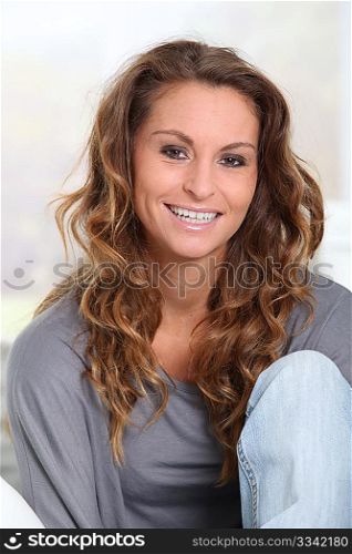 Portrait of beautiful smiling woman relaxing in sofa