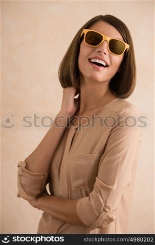 Portrait of beautiful smiling young woman wearing sunglasses