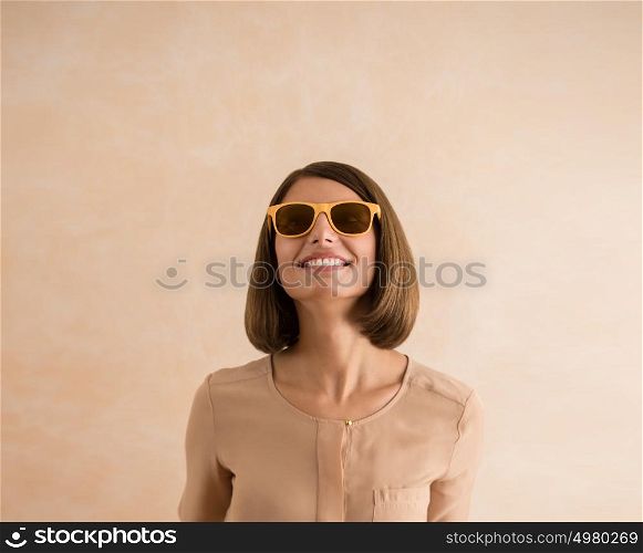 Portrait of beautiful smiling young woman wearing sunglasses. Lots of copyspace