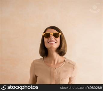 Portrait of beautiful smiling young woman wearing sunglasses. Lots of copyspace