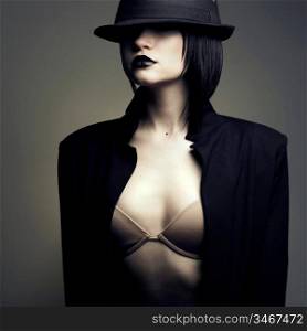 Portrait of beautiful stylish lady in hat. Studio fashion photo