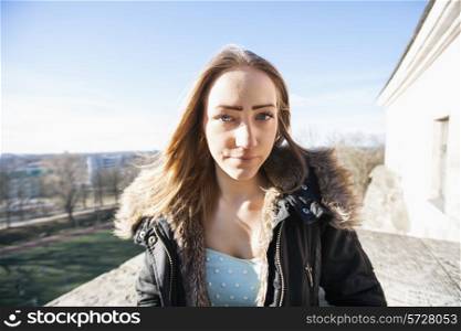 Portrait of beautiful teenage girl in jacket outdoors