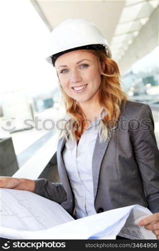Portrait of beautiful woman architect looking at plan