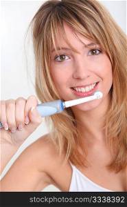 Portrait of beautiful woman brushing her teeth