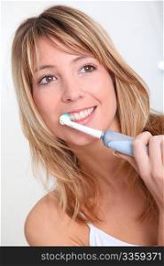 Portrait of beautiful woman brushing her teeth