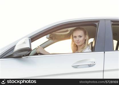 Portrait of beautiful woman driving car