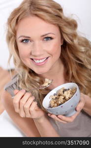 Portrait of beautiful woman eating cereals