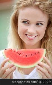 Portrait of beautiful woman eating fresh fruits