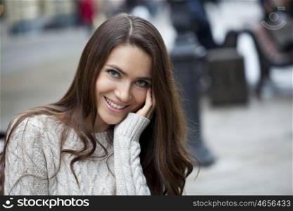 Portrait of beautiful woman in autumn street