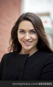 Portrait of beautiful woman in autumn street