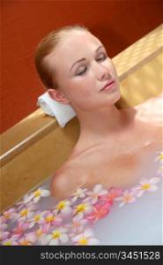 Portrait of beautiful woman in milk bath