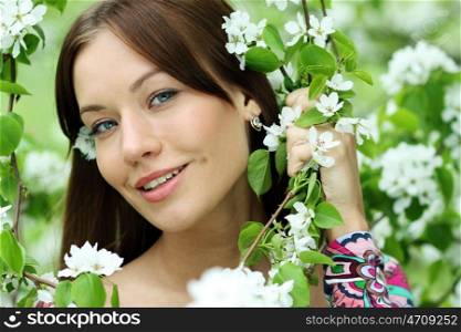 Portrait of beautiful woman in spring blossom