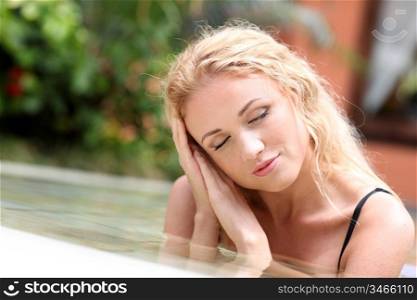 Portrait of beautiful woman in swimming pool