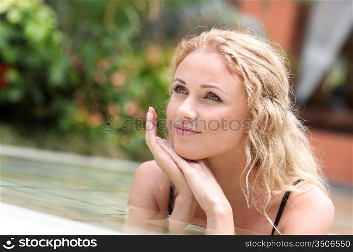 Portrait of beautiful woman in swimming pool