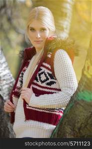 Portrait of beautiful woman in warm clothing standing in park