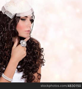 Portrait of beautiful woman isolated on white background, elegant bride, wearing stylish hat with veil, black curly hair, fashionable look