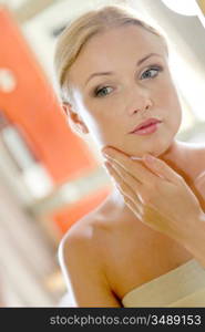 Portrait of beautiful woman looking at a mirror