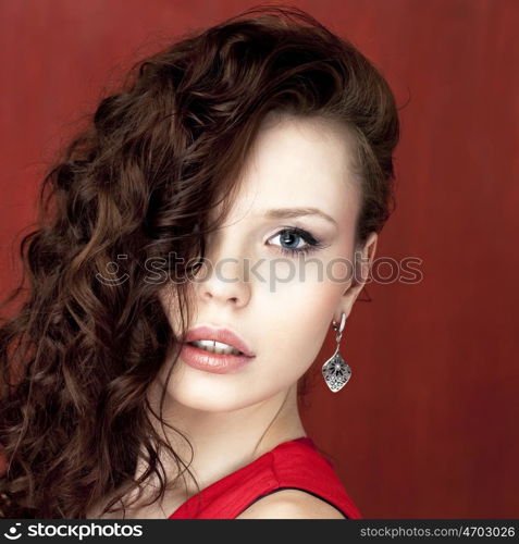 Portrait of beautiful woman on red background