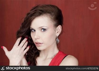 Portrait of beautiful woman on red background
