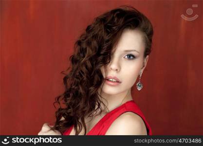 Portrait of beautiful woman on red background
