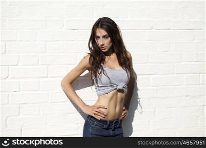 Portrait of beautiful woman on the background of white brick