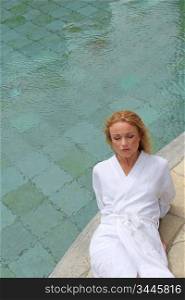 Portrait of beautiful woman resting by spa pool