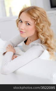 Portrait of beautiful woman sitting in sofa